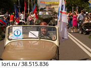 KALININGRAD, RUSSIA - JULY 14: man drives his retro car on the street on City Day of Kaliningrad celebration on July 14, 2013 in Kaliningrad, Russia. Редакционное фото, фотограф Lekcej / Фотобанк Лори