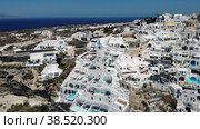 Oia village Santorini with whitewashed house and swimming pools Santorini Greece Europe. Стоковое видео, видеограф Fokke Baarssen / Фотобанк Лори