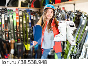Smiling young girl chose skis, shelm and boots. Стоковое фото, фотограф Яков Филимонов / Фотобанк Лори
