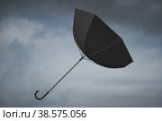 Umbrella blown away by the wind. Windy weather. Стоковое фото, фотограф Happyphotons / Фотобанк Лори