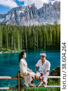 couple visit a bleu lake in the dolomites Italy, Carezza lake Lago di Carezza, Karersee. Стоковое фото, фотограф Fokke Baarssen / Фотобанк Лори