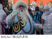 Сагаан Убген (бурятский Дед Мороз) поздравляет людей на Манежной площади в рамках акции "Хранители зимних традиций" на фестивале "Путешествие в Рождество" в Москве, Россия (2023 год). Редакционное фото, фотограф Николай Винокуров / Фотобанк Лори