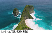 Kelingking Beach Nusa Penida Bali Island famous tourist attraction in Indonesia. Incredible must viisit place on vacations. Amazing coastline. Aerial view of tropical ocean landscape. Стоковое видео, видеограф Ольга Сухарева / Фотобанк Лори