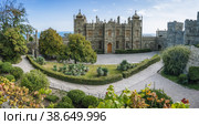Vorontsov Palace in Alupka, Crimea. Panoramic view of castle with blue sky background. Yucca bushes and trees are in foreground (2021 год). Стоковое фото, фотограф Igor Tichonow / Фотобанк Лори