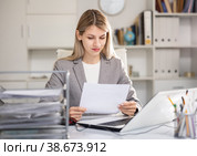 Woman working in office with documents and laptop. Стоковое фото, фотограф Яков Филимонов / Фотобанк Лори