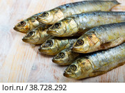 Salted sardines on wooden surface. Стоковое фото, фотограф Яков Филимонов / Фотобанк Лори
