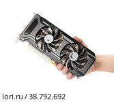 The hand holds a powerful video card with two fans. Close up. Isolated on a white background. Стоковое фото, фотограф Плотников Дмитрий / Фотобанк Лори