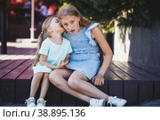 beautiful young girls are sitting on the veranda and are secret. Стоковое фото, фотограф Поликарпов Владимир Владимирович / Фотобанк Лори