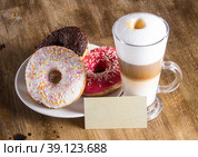 Латте в высоком прозрачном стакане с тремя донатами на тарелке и визиткой. Стоковое фото, фотограф Александр Игоревич Минаков / Фотобанк Лори