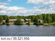 MANDROGI, RUSSIA - JUNE 8, 2015: Karelia region, old wooden houses on the banks of the Svir River. Restored ancient village, the berth of tourist ships. Стоковое фото, фотограф Оксана Медведева / Фотобанк Лори