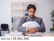 Young male employee in oversleeping concept. Стоковое фото, фотограф Elnur / Фотобанк Лори