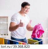 Man doing laundry at home. Стоковое фото, фотограф Elnur / Фотобанк Лори