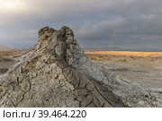 Mud volcanoes of Gobustan near Baku, Azerbaijan. Mud mountain against the backdrop of a stormy sky. (2019 год). Стоковое фото, фотограф Михаил Пряхин / Фотобанк Лори