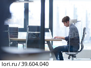 businessman working using a laptop in startup office. Стоковое фото, фотограф Benis Arapovic / PantherMedia / Фотобанк Лори