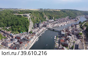 Aerial view of Walloon city of Dinant located along Meuse river with Gothic medieval Collegiate Church of Our Lady and fortified castle perched atop green vertical cliff in summer, Belgium. Стоковое видео, видеограф Яков Филимонов / Фотобанк Лори
