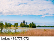 Kizhi Island, Karelia, Russia. The view from the water of a unique ancient architectural ensemble of traditional wooden folk architecture. UNESCO World Heritage Site in Russia.Summer sunny day. (2015 год). Стоковое фото, фотограф Оксана Медведева / Фотобанк Лори