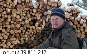 An elderly man gives an interview about logging near timber. Стоковое видео, видеограф Владимир Григорьев / Фотобанк Лори