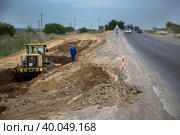 South Kazakhstan - April, 26 2012: Development of West Europe-West China highway. Groundworks with bulldozer. Редакционное фото, фотограф Alexey Rezvykh / Фотобанк Лори