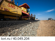 Kyzylorda province, Kazakhstan, April 29, 2012: Construction of West Europe-West China new highway. Dynapac road machine puts hot asphalt. Стоковое фото, фотограф Alexey Rezvykh / Фотобанк Лори