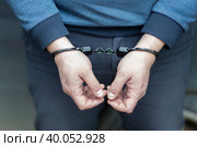 The perpetrator is a man in handcuffs. Criminal news.Detention of a criminal. Стоковое фото, фотограф Александр Поташев / Фотобанк Лори