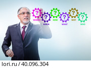 Concept of many different questions asked with businessman. Стоковое фото, фотограф Elnur / Фотобанк Лори