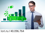 Electric car concept with businessman pressing button. Стоковое фото, фотограф Elnur / Фотобанк Лори