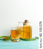 Homemade fermented Kombucha drink, in a glass, serving bottle, can of Kombucha mushroom and centimeter tape. Стоковое фото, фотограф Bogdanova Mariia / Фотобанк Лори