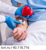 Male patient getting blood transfusion in hospital clinic. Стоковое фото, фотограф Elnur / Фотобанк Лори