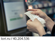 Point of Sale System For Retail product receipt in women's hands in the store - Credit Card Processor, Receipt Printer with paper shopping bill and Touch screen monitor. Стоковое фото, фотограф Владимир Разгуляев / Фотобанк Лори