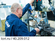 Milling-machine operator works at the machine (2019 год). Редакционное фото, фотограф Сергей Буторин / Фотобанк Лори