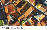 Aerial view of small rural town with red roofs during sunrise time (2019 год). Стоковое видео, видеограф Кирилл Трифонов / Фотобанк Лори