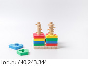 Children's wooden educational toy. Sorter with different color details. Close-up on a white background. Стоковое фото, фотограф Bogdanova Mariia / Фотобанк Лори