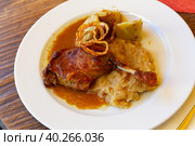 Roasted confit du canard with sauerkraut, potato dumplings and onion. Стоковое фото, фотограф Яков Филимонов / Фотобанк Лори