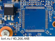 A fragment of a blue computer board with capacitors and desoldering for a microprocessor. Стоковое фото, фотограф Сергей Фролов / Фотобанк Лори