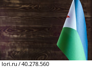 Фрагмент флага Республики Джибути на цветном деревянном фоне место для текста (2019 год). Стоковое фото, фотограф Лозовая Людмила / Фотобанк Лори