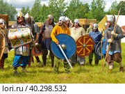 Pskov, Russia, July 10. 2022. Epic Invading Army of Medieval Knights on Battlefield, Plate Body Armored Soldiers with Swords in Battle Cry. Historical Reenactment. Редакционное фото, фотограф Ирина Старикова / Фотобанк Лори