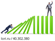 Businessman in domino effect concept. Стоковое фото, фотограф Elnur / Фотобанк Лори