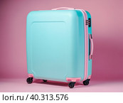 A blue large suitcase on a soft pink background. A symbol of travel and vacation. Стоковое AI-изображение, AI-художник Ярославский Максим / Фотобанк Лори