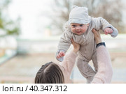 Cute little boy playing with his mom outside. A happy child is tossed up in the park. The kid laughs merrily. Portrait of a boy. Mothers Day. Стоковое фото, фотограф Photojuli / Фотобанк Лори