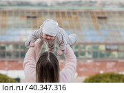 Cute little boy playing with his mom outside. A happy child is tossed up in the park. The kid laughs merrily. Portrait of a boy. Mothers Day. Стоковое фото, фотограф Photojuli / Фотобанк Лори
