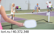 Man and woman training to play pickleball tennis on the pickleball cour. Стоковое фото, фотограф Яков Филимонов / Фотобанк Лори