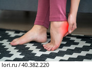 Plantar fasciitis, heel spur, foot pain, man suffering from feet ache at home. Стоковое фото, фотограф Станислав Тарко / Фотобанк Лори