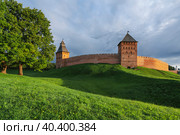 View of the wall of the Novgorod Kremlin, the Dvortsovaya and Spasskaya Towers on an early cloudy summer morning, Veliky Novgorod, Novgorod region, Russia. Стоковое фото, фотограф Ula Ulachka / Фотобанк Лори