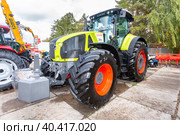 Modern agricultural wheeled tractor Claas 950 Axion at the annual Volga agro-industrial exhibition (2019 год). Редакционное фото, фотограф FotograFF / Фотобанк Лори