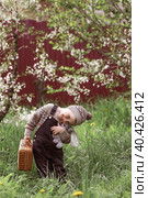 A little boy of 4 years old outdoors with a suitcase and a stuffed rabbit goes on a journey. A beautiful portrait of a child playing on the street. Стоковое фото, фотограф Photojuli / Фотобанк Лори
