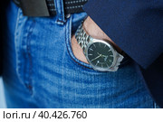 Pskov, Russia - August 09, 2022: - Close up fashion image of Victorinox watch on rest of man's: man's hand in blue jeans pocket. Редакционное фото, фотограф Ирина Старикова / Фотобанк Лори