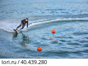 Motosurf Competitor taking corner at speed making a lot of spray. Jet surfing on a water, man riding on jet surfboard. Surfer in motion, summer sport. Стоковое фото, фотограф Олег Спиридонов / Фотобанк Лори