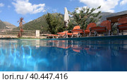 Video of a Greek landscape with a palm tree in the foreground. and tourist hotel under a mountain on background. Crete, Greece. Стоковое видео, видеограф Сергей Пристяжнюк (Serg Zastavkin) / Фотобанк Лори