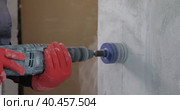 An electrician drills holes for sockets with a diamond core bit. Close-up. Стоковое видео, видеограф Юрий Поздников / Фотобанк Лори