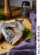 Raw peeled dorado fish with cooking ingredients. Fresh fish on a wooden background. Стоковое фото, фотограф Юрий Поздников / Фотобанк Лори